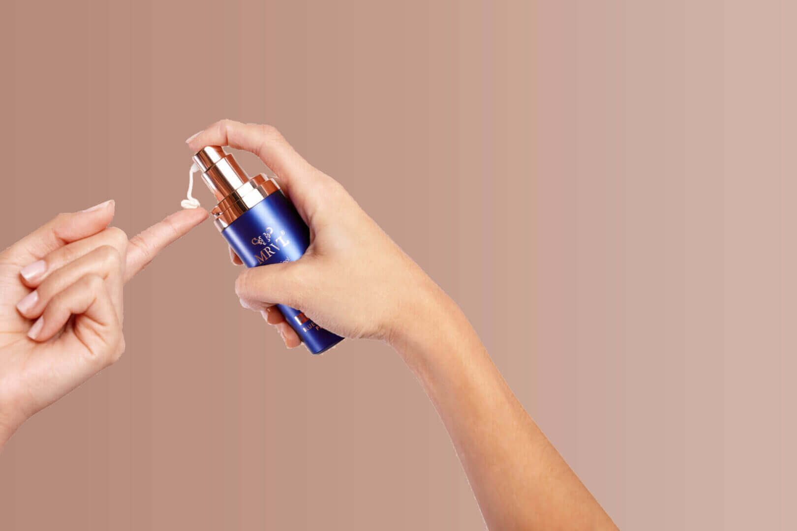 Hands holding a MRVL serum bottle with a dropper